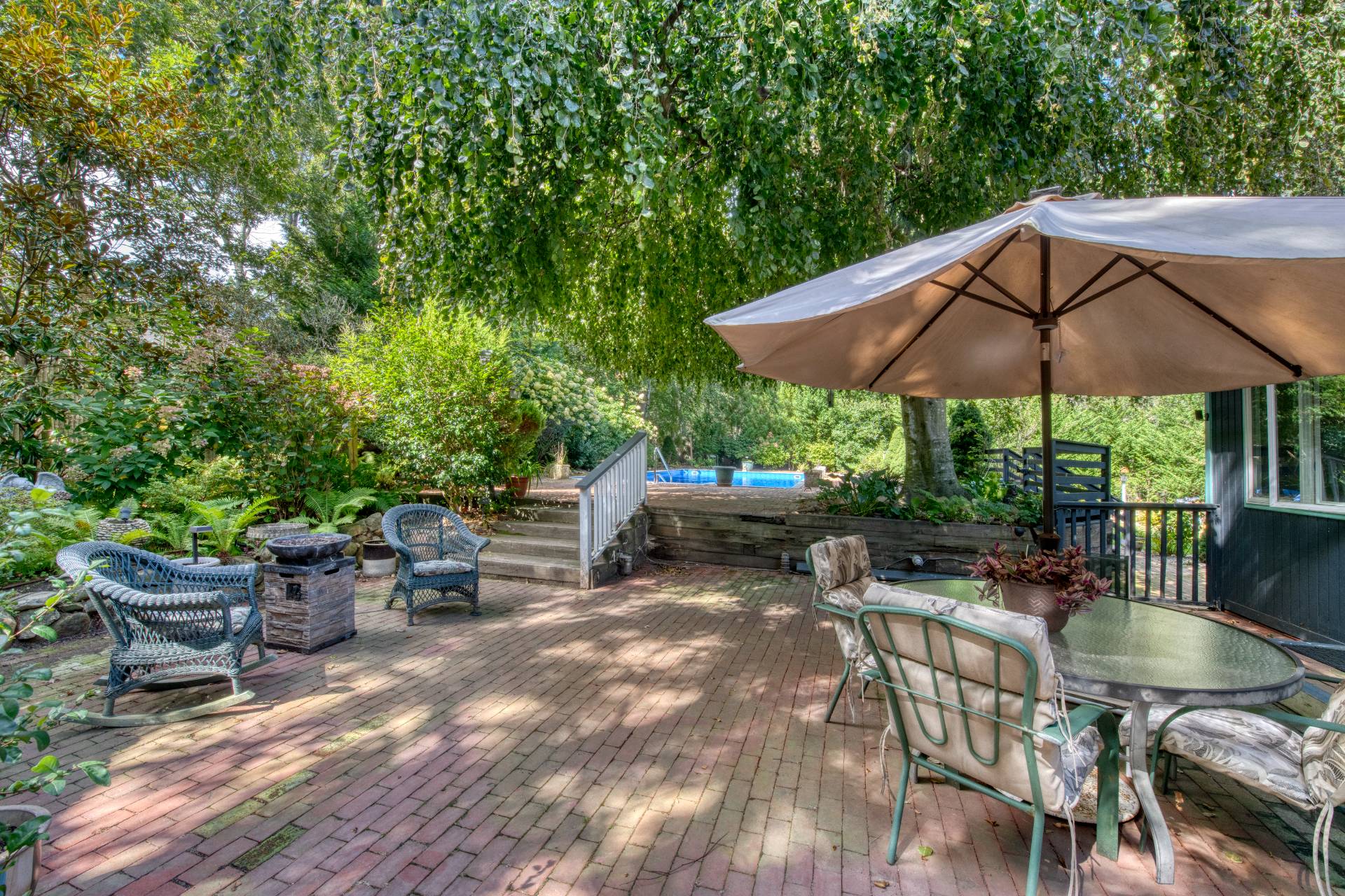 1 Abigails Path East Hampton, NY 11937 - Photo 4 of 18 a patio with a patio table and chairs