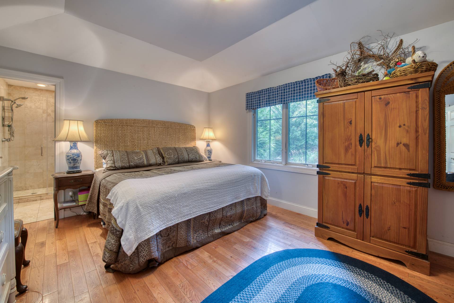 1 Abigails Path East Hampton, NY 11937 - Photo 7 of 18 a bedroom with a bed and wooden floor