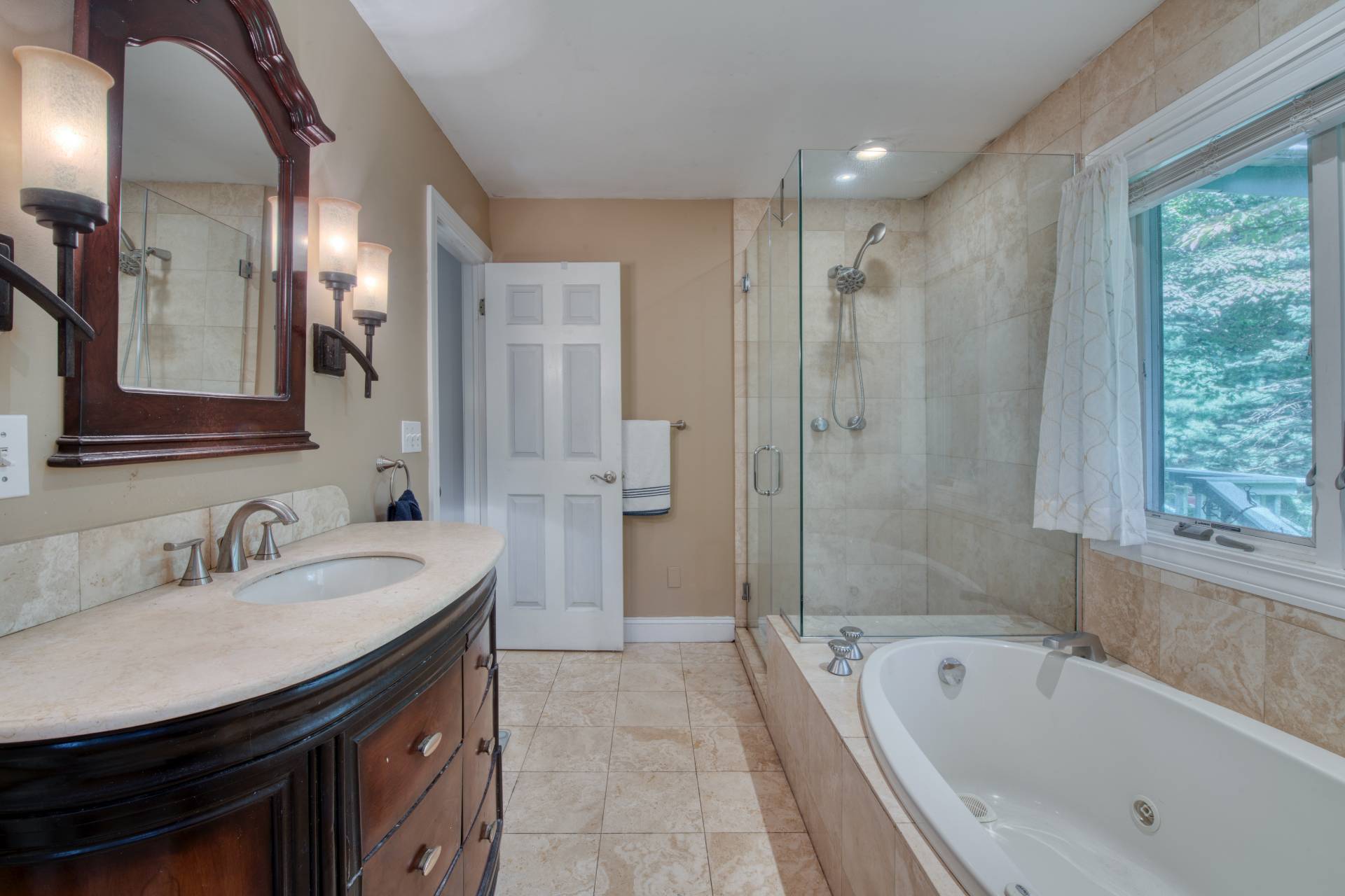 1 Abigails Path East Hampton, NY 11937 - Photo 8 of 18 a bathroom with a tub sink double vanity granite tub shower and mirror