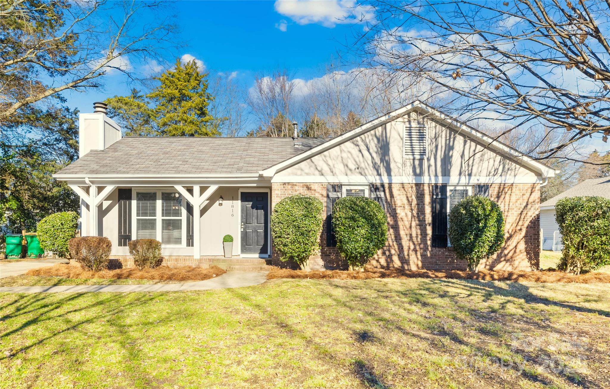 11816 Park Road Charlotte, NC 28226 - Photo 1 of 26 a front view of house with a yard and potted plants