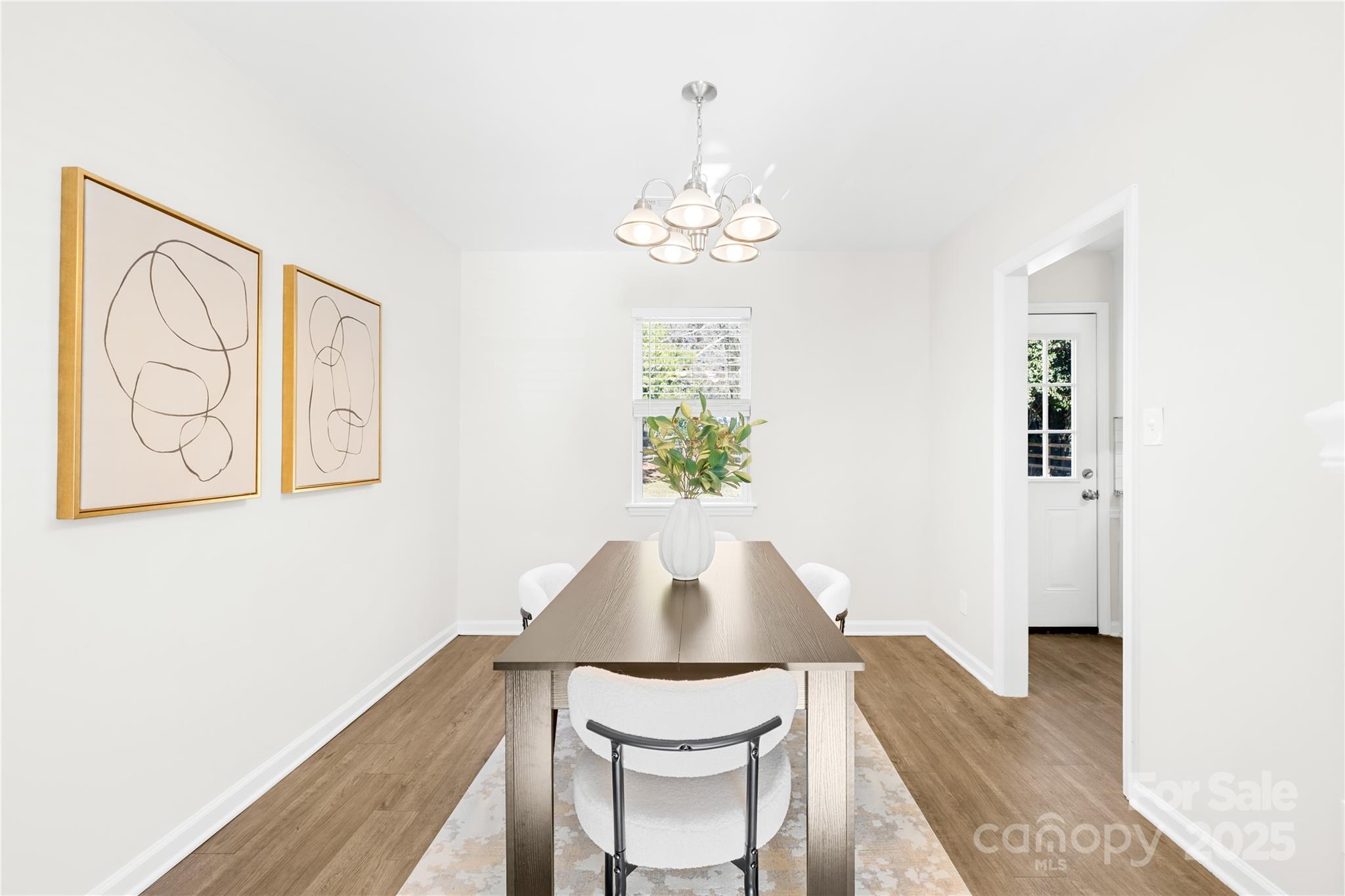 11816 Park Road Charlotte, NC 28226 - Photo 11 of 26 a view of a dining room with furniture and wooden floor