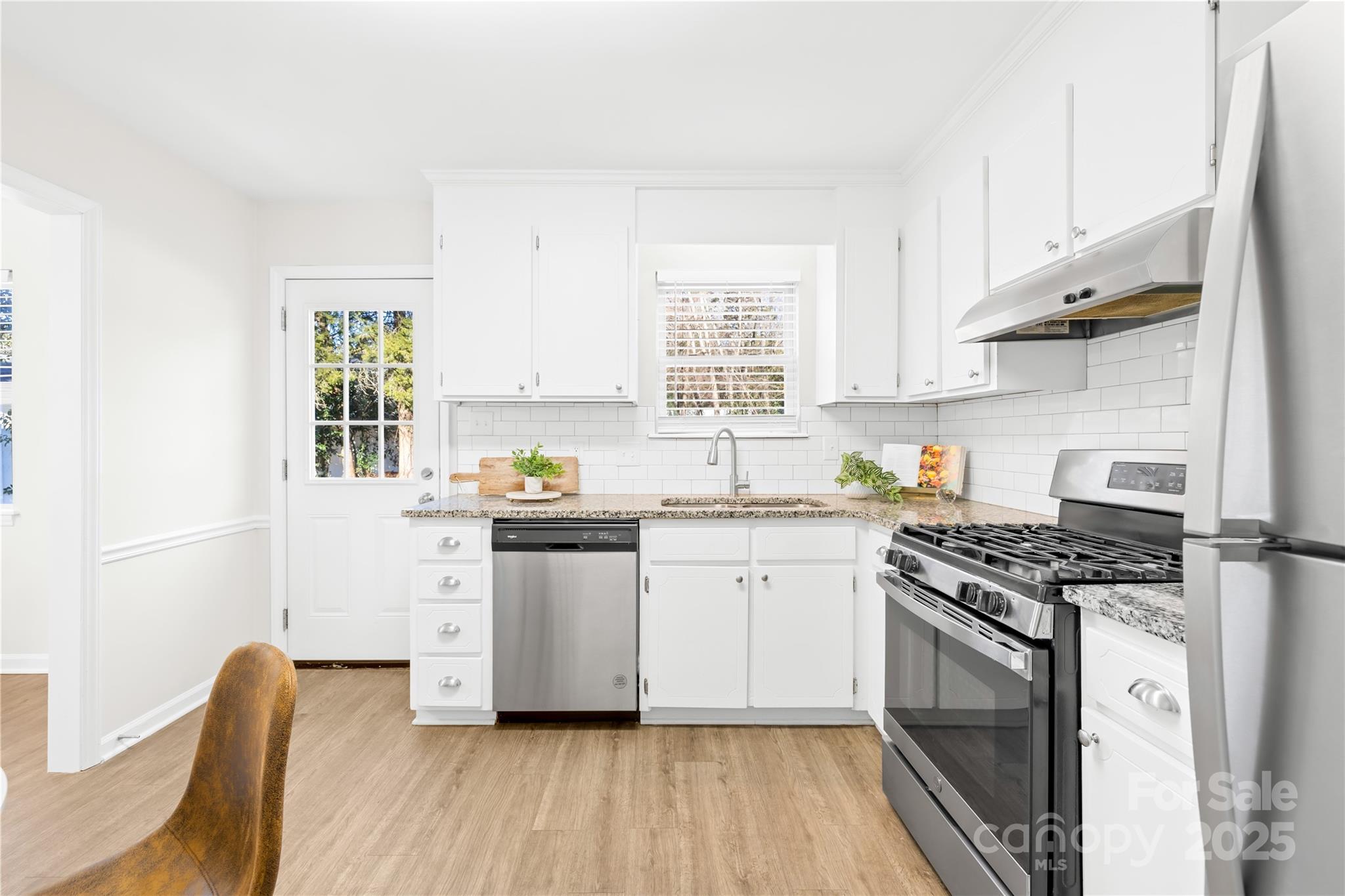 11816 Park Road Charlotte, NC 28226 - Photo 13 of 26 a kitchen with stainless steel appliances granite countertop a stove a sink and a refrigerator