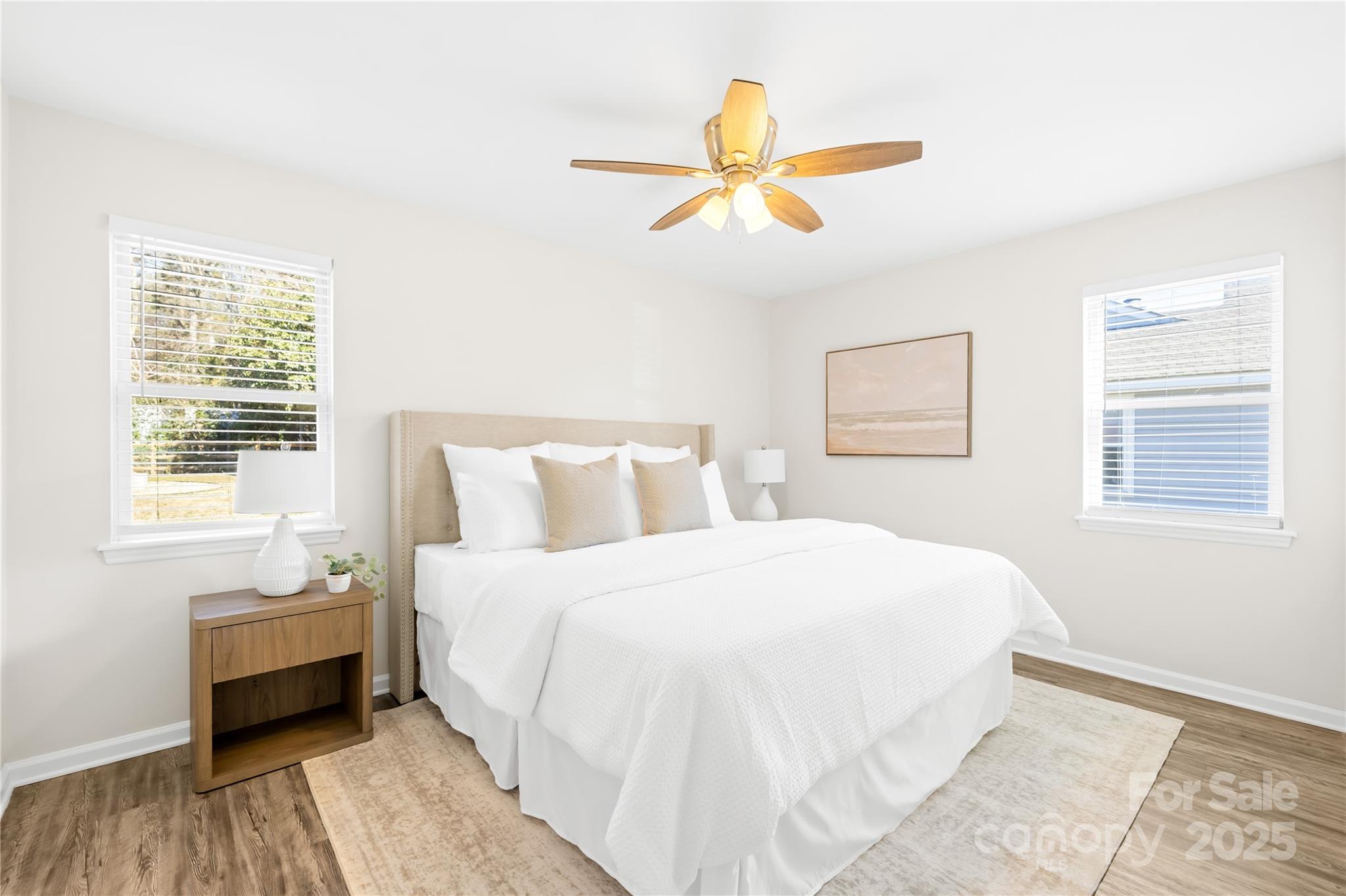 11816 Park Road Charlotte, NC 28226 - Photo 15 of 26 a bedroom with a bed and a chandelier