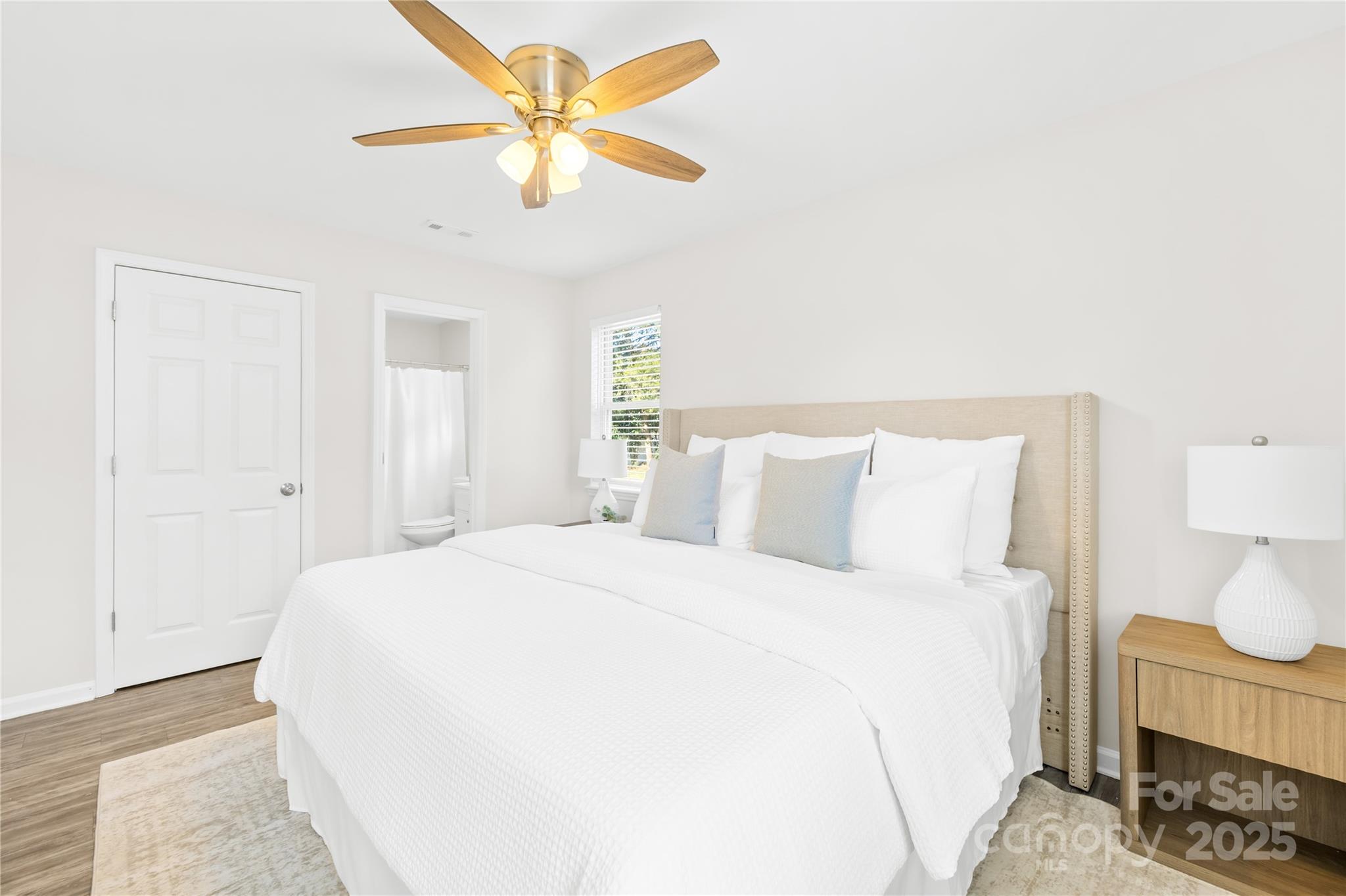 11816 Park Road Charlotte, NC 28226 - Photo 16 of 26 a spacious bedroom with a bed and a chandelier