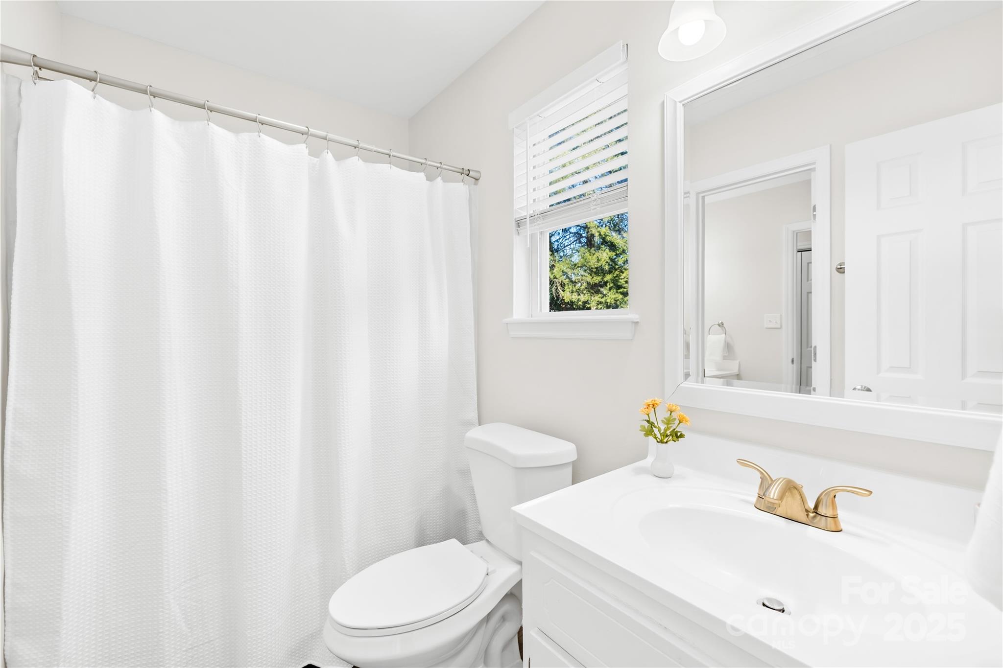 11816 Park Road Charlotte, NC 28226 - Photo 17 of 26 a white toilet sitting next to a bathroom sink