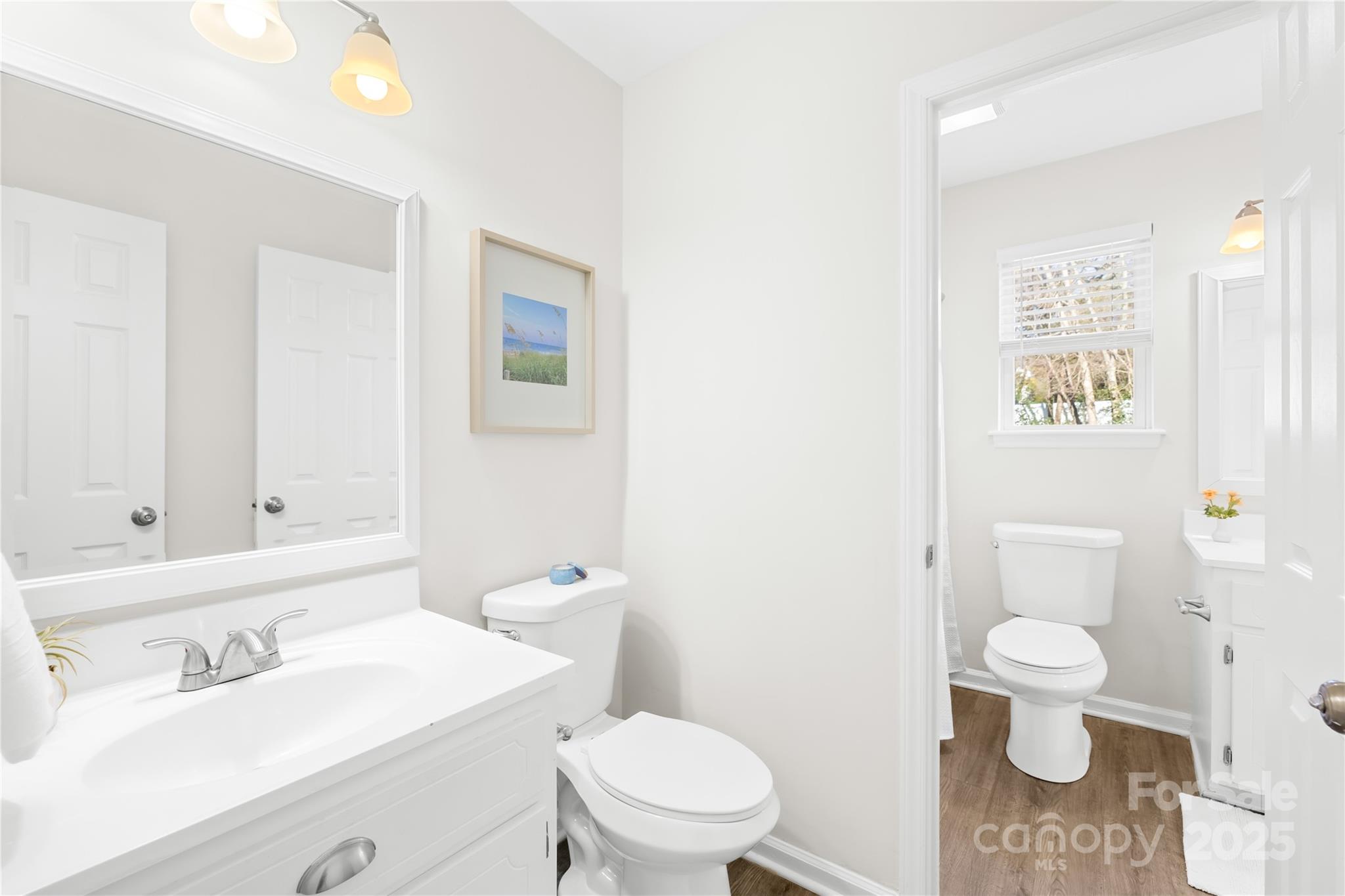 11816 Park Road Charlotte, NC 28226 - Photo 20 of 26 a bathroom with a toilet a sink and a mirror