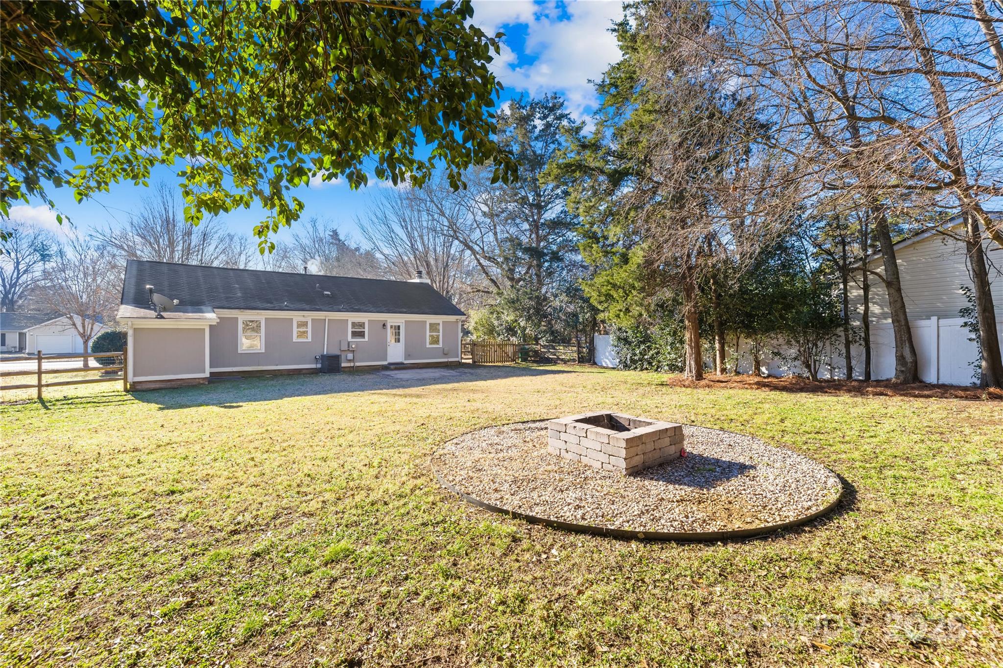 11816 Park Road Charlotte, NC 28226 - Photo 22 of 26 a view of a swimming pool with an outdoor seating