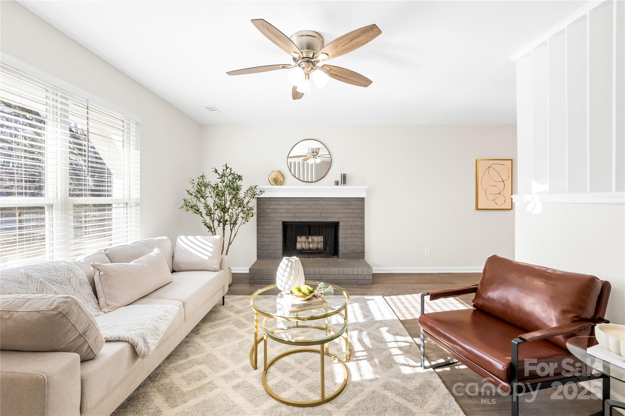 11816 Park Road Charlotte, NC 28226 - Photo 6 of 26 a living room with furniture a fireplace and a large window