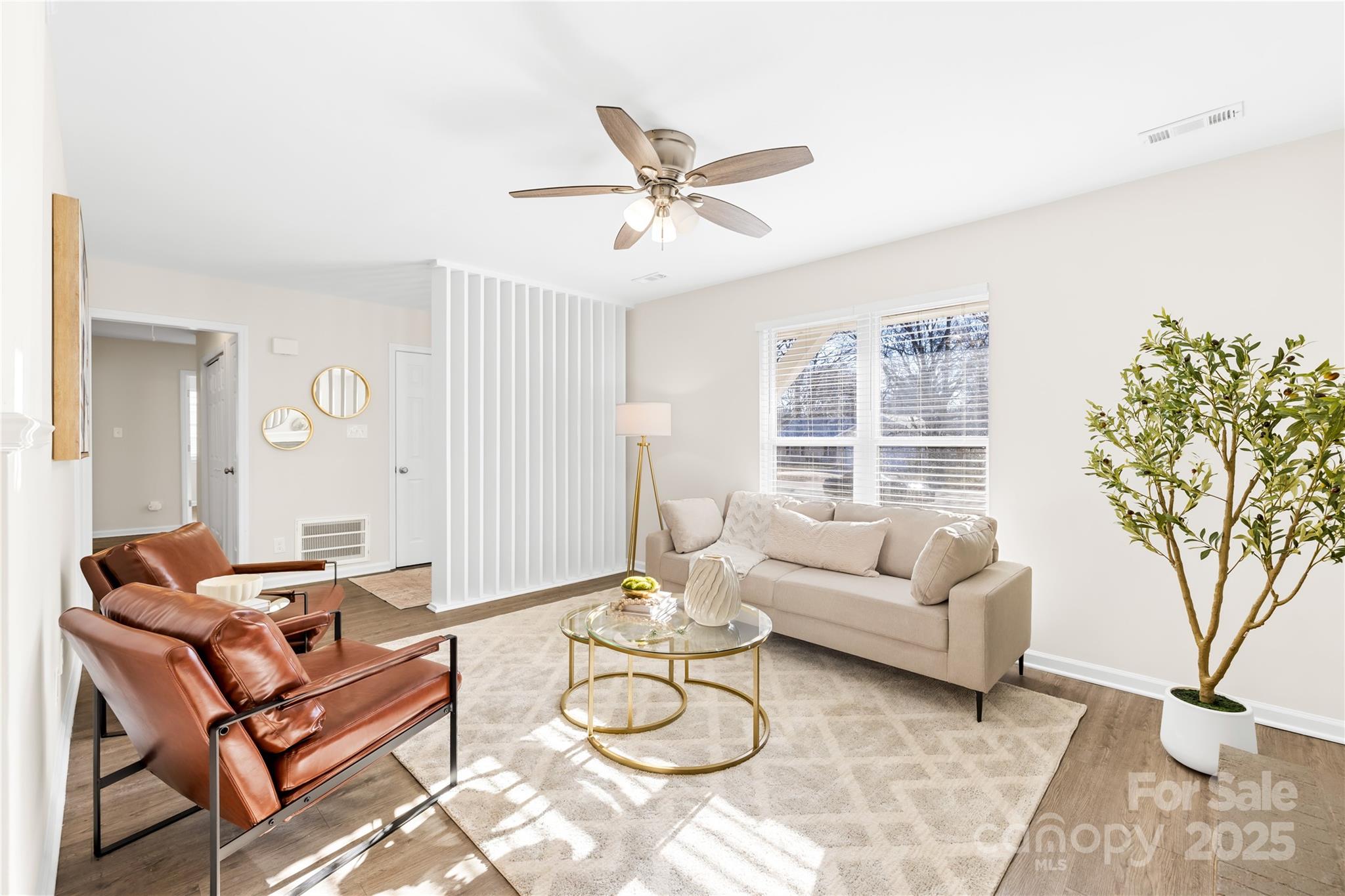 11816 Park Road Charlotte, NC 28226 - Photo 7 of 26 a living room with furniture a large window and a chandelier
