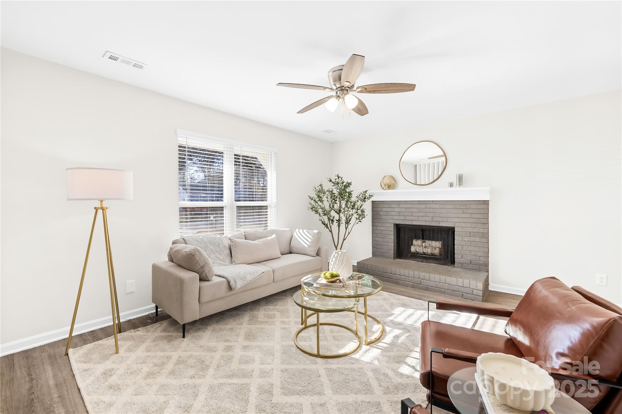 11816 Park Road Charlotte, NC 28226 - Photo 8 of 26 a living room with furniture a fireplace and a large window