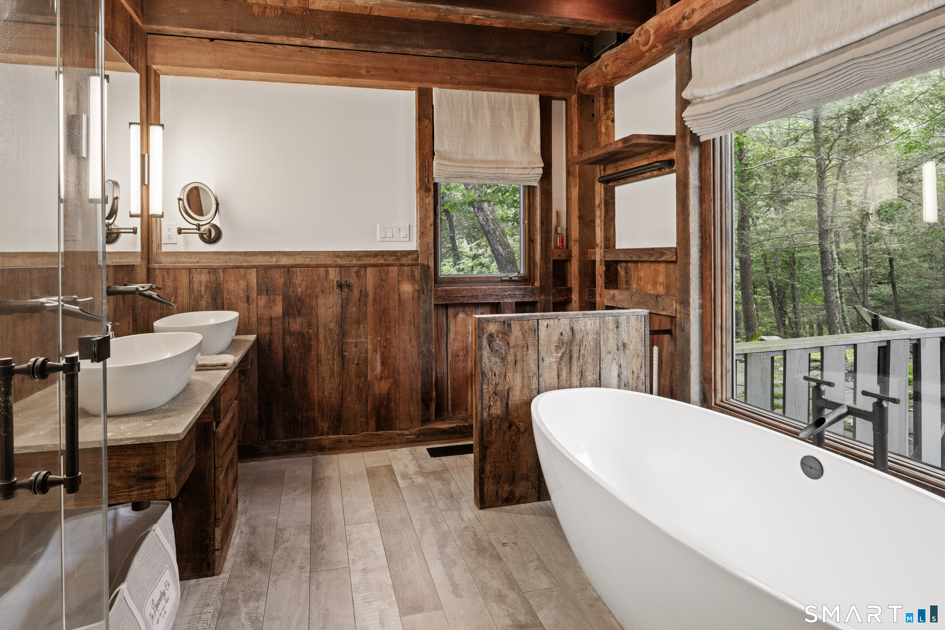129 Davis Hill Road Weston, CT 06883 - Photo 26 of 40 a bathroom with a bathtub a sink a mirror and a window