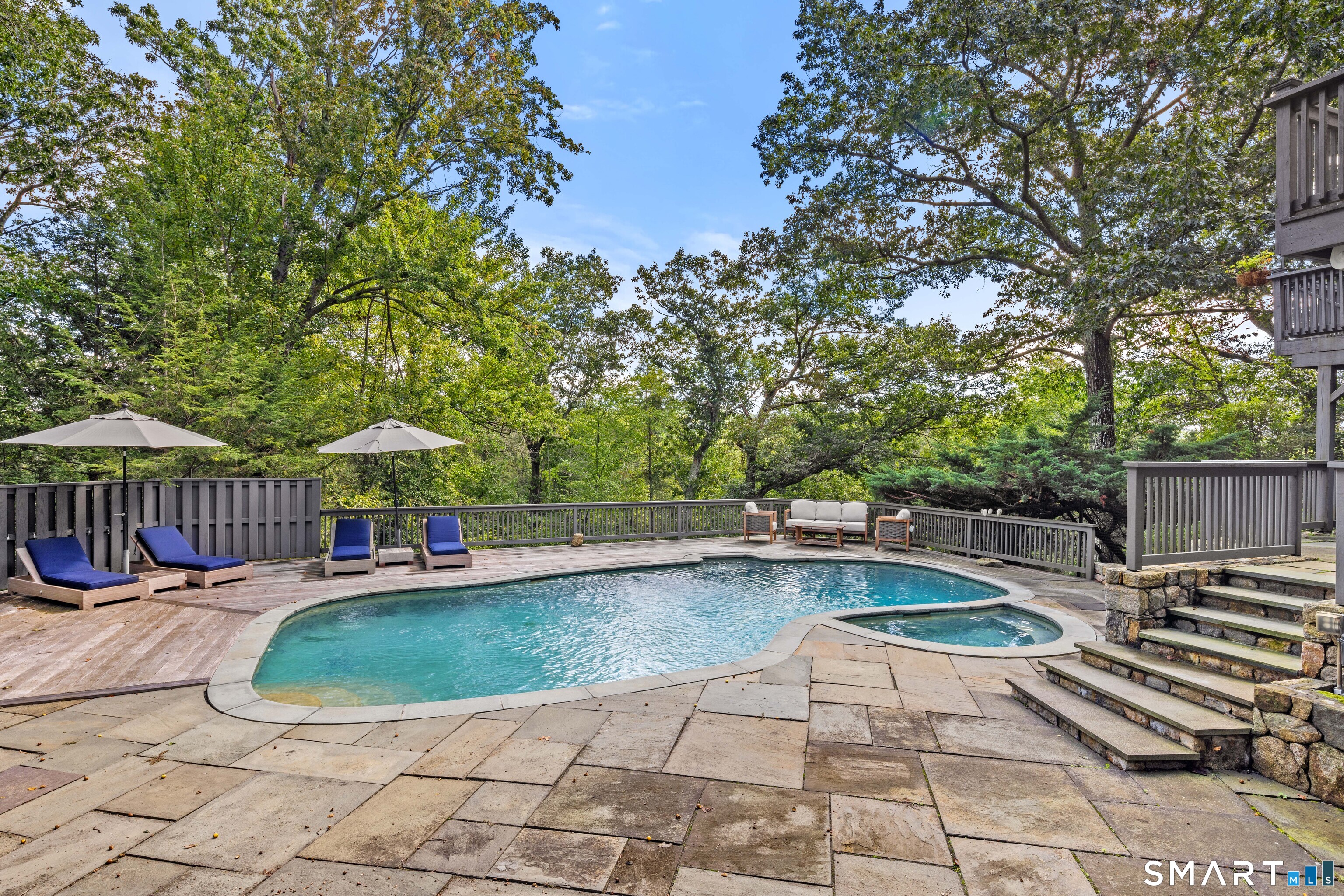 129 Davis Hill Road Weston, CT 06883 - Photo 7 of 40 a view of a swimming pool with lounge chair