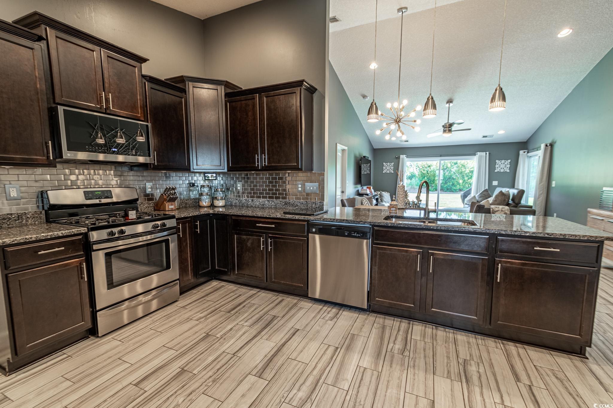 793 Old Castle Loop Myrtle Beach, SC 29579 - Photo 11 of 39 Kitchen with high vaulted ceiling, stainless steel