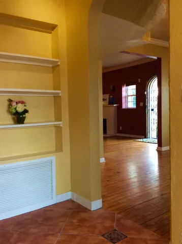 a view of a hallway with wooden floor