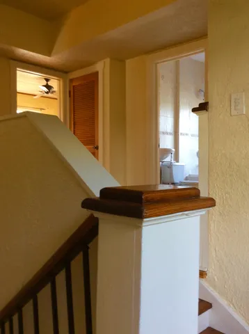 an empty room with wooden floor and a window
