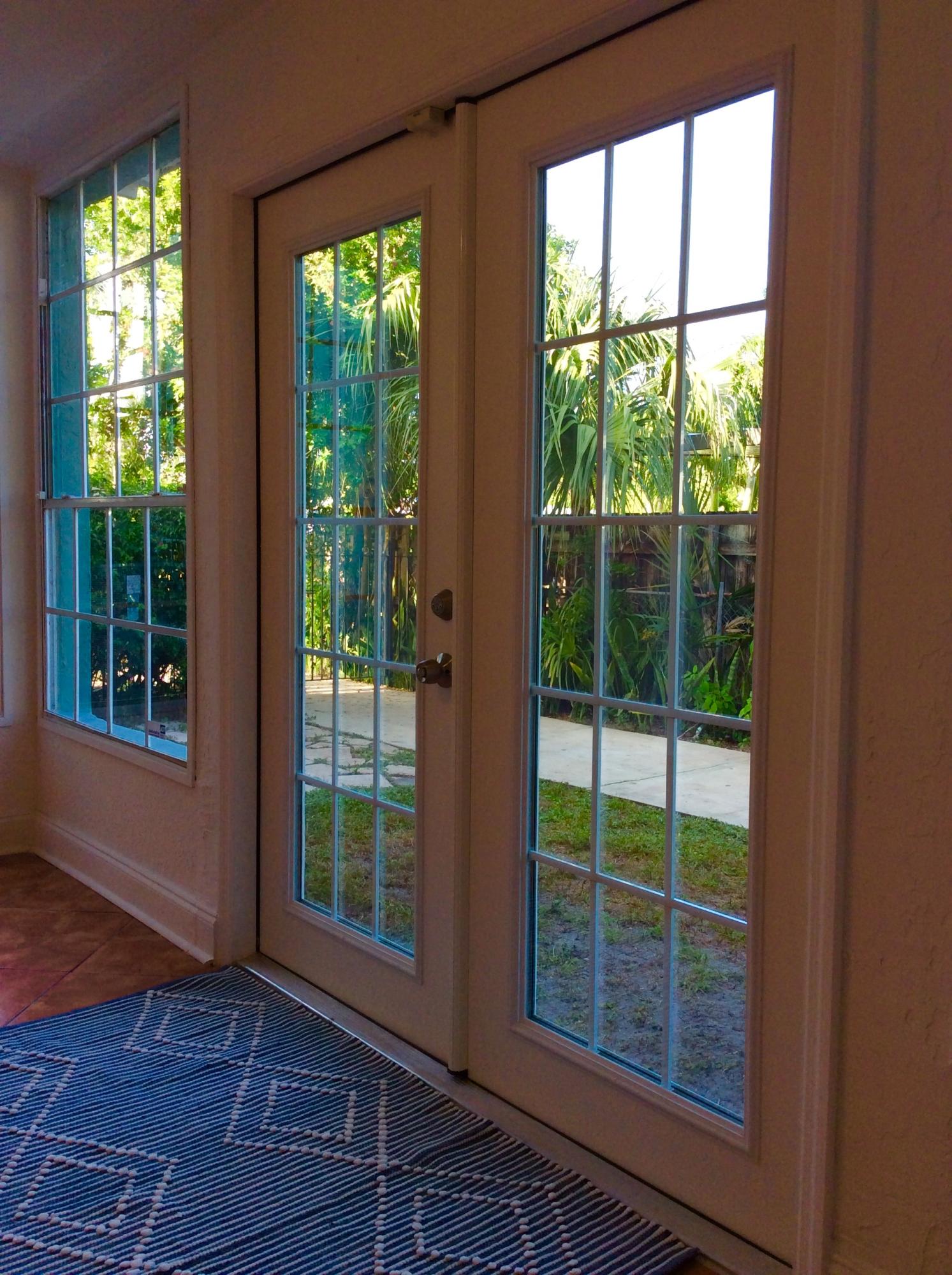382 Ellamar Road West Palm Beach, FL 33405 - Photo 35 of 39 a view of empty room with wooden floor and windows