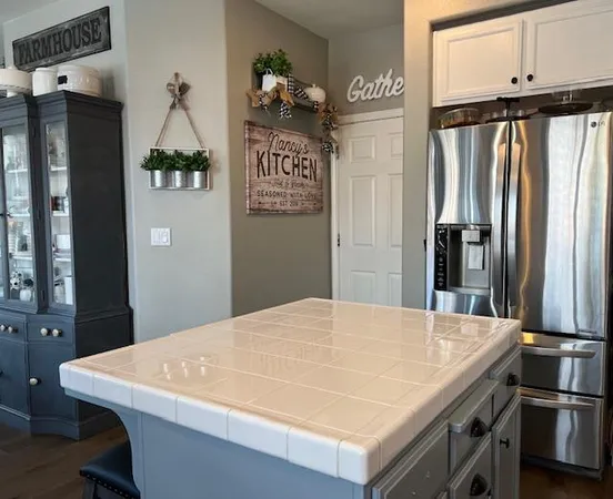 a kitchen with a table chairs a stove and a refrigerator
