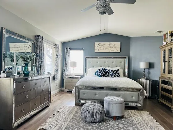 a bedroom with a bed and wooden floor