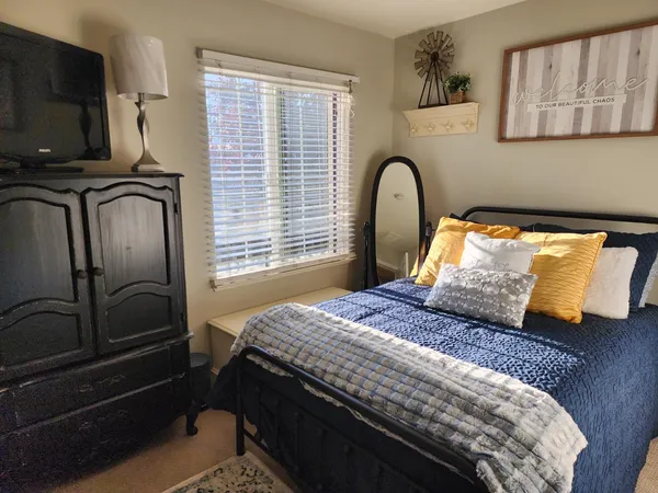 a bedroom with bed and window