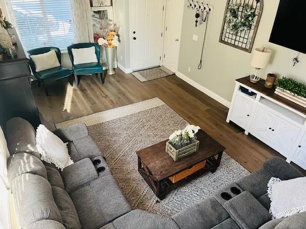 a living room with furniture and wooden floor