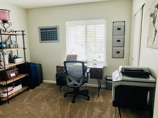 a bedroom with a workspace