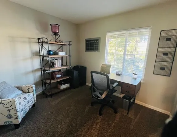 a patio with a table and chairs under an umbrella