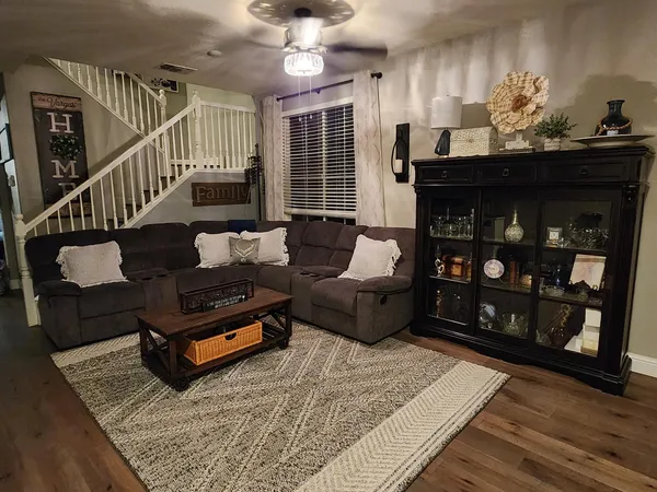 a living room with furniture a rug and a chandelier