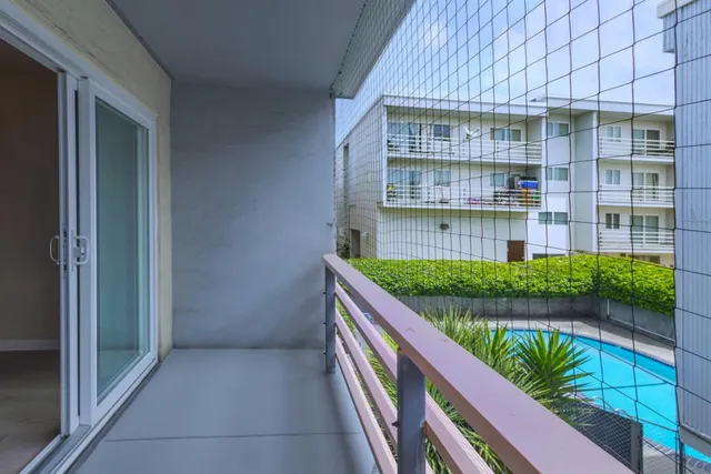 a bathroom with a granite countertop double vanity sink and a mirror