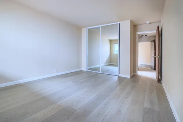 a kitchen with kitchen island granite countertop a stove refrigerator and cabinets