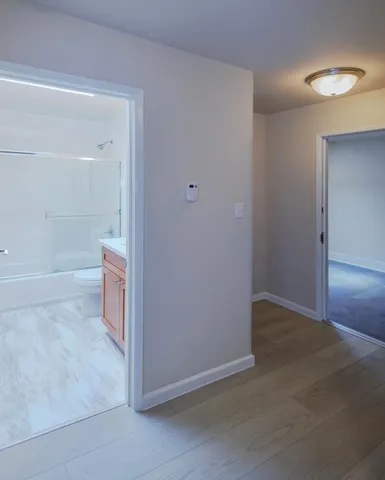 a bedroom with a bed and a flat tv screen on the dresser