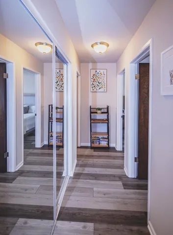 a large bed sitting in a bedroom next to a window and a lamp