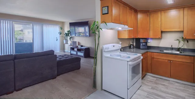 a kitchen with a sink a stove a refrigerator and cabinets