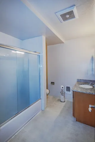 a bed sitting in a room next to a lamp