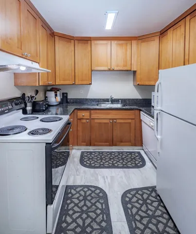 a view of a hallway with wooden floor and windows
