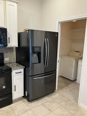 an empty room with wooden floor chandelier fan and closet area