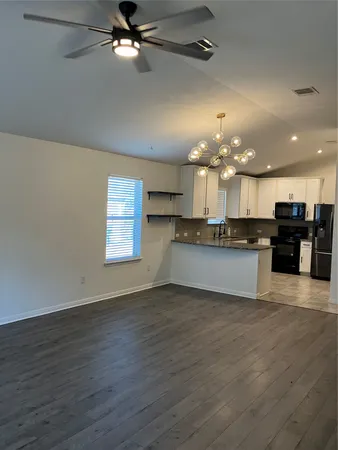a swimming pool with an outdoor space and seating area