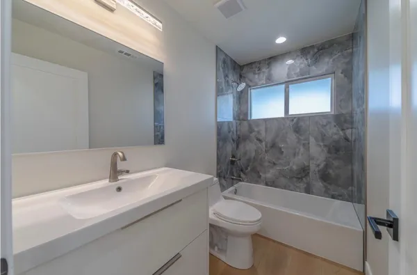 a bathroom with a toilet a sink and a bathtub