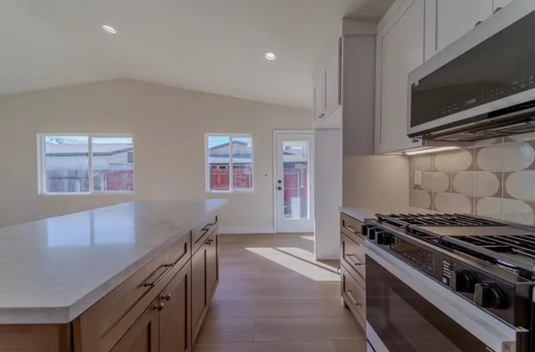 a kitchen with stainless steel appliances a stove a microwave and a refrigerator