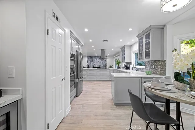 a living room with furniture a fireplace and a potted plant