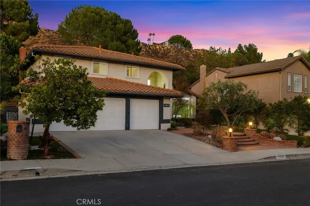 a view of a patio with a table and chairs under an umbrella