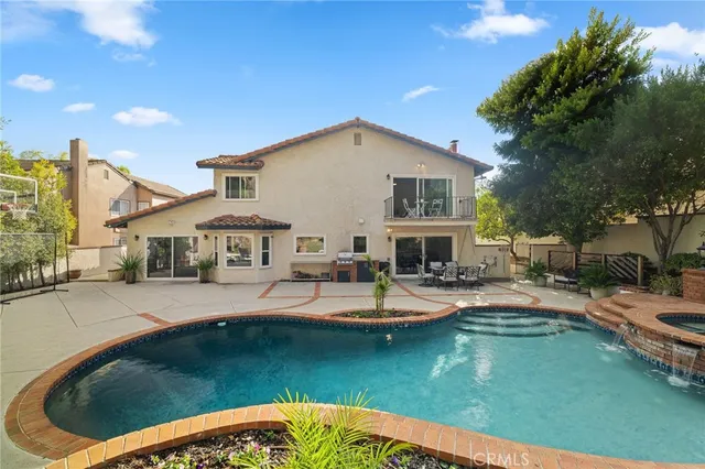 a living room with fireplace furniture and a chandelier