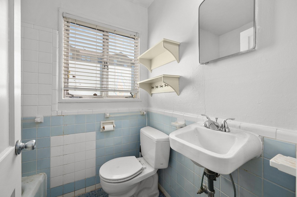 1302 Norwalk Lane Austin, TX 78703 - Photo 12 of 34 a white toilet sitting next to a bathroom sink