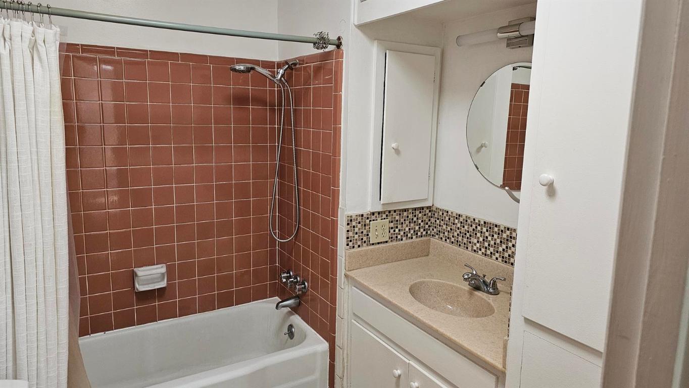 1302 Norwalk Lane Austin, TX 78703 - Photo 22 of 34 a bathroom with a shower a bath tub and a sink