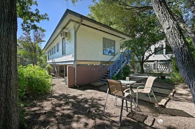 a view of a chair and table in backyard