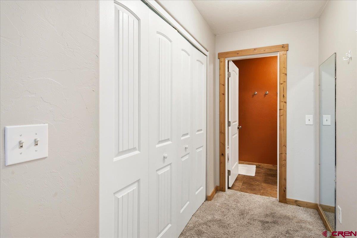 520 Redcliff Circle, Unit G203 Ridgway, CO 81432 - Photo 9 of 25 a view of a hallway with closet and bathroom