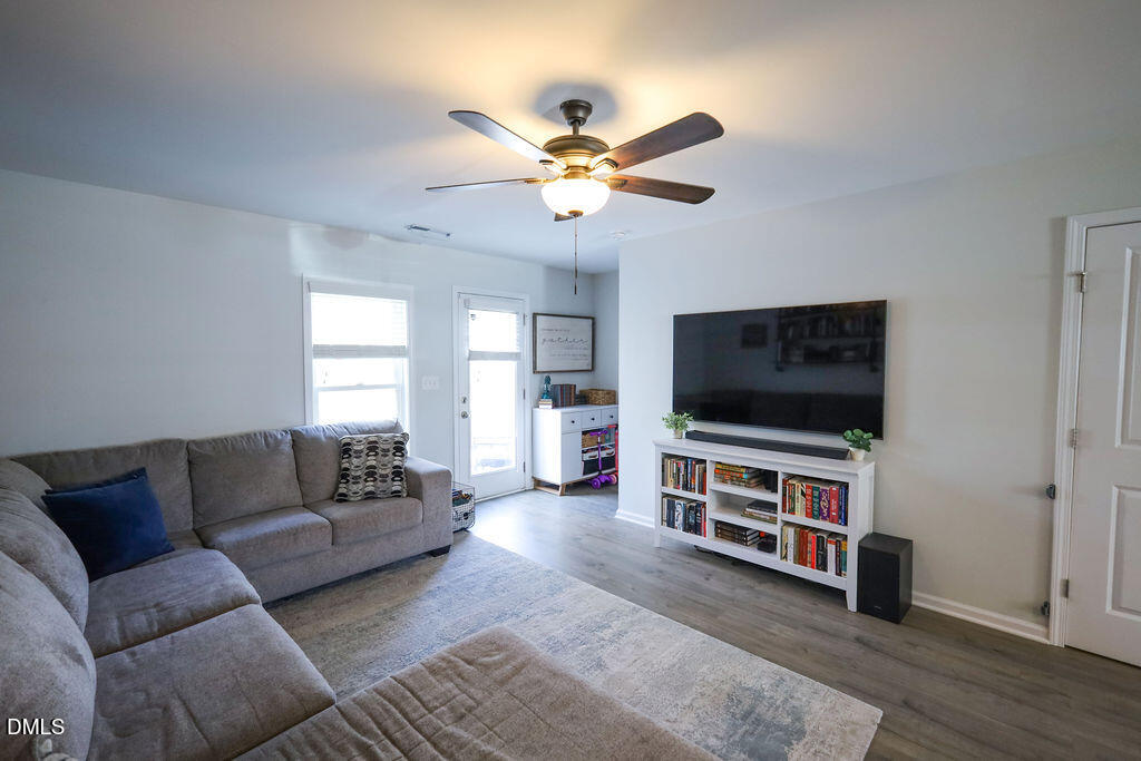 230 South Raleigh Street Angier, NC 27501 - Photo 16 of 38 a living room with furniture and a flat screen tv