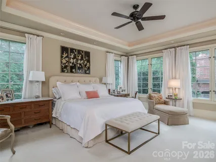 a bedroom with a bed couch and window
