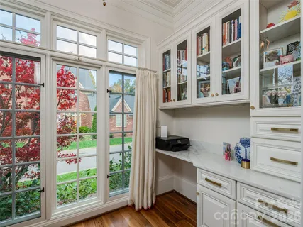 a kitchen with stainless steel appliances cabinets and a large window