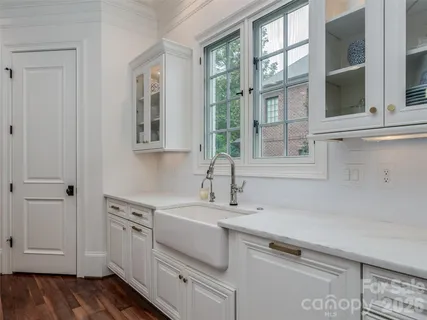 a view of a sink and dishwasher with wooden floor