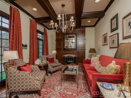 a living room with furniture a chandelier and a window